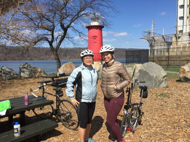 Joanna (left) and her friend, Emily Liu, stop for a photo at the Little Red Lighthouse in Fort Washington Park while on a social ride with WE Bike NYC