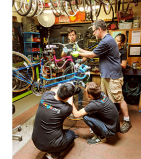 GoogleServe's volunteer squad showing that teamwork makes the bike work.